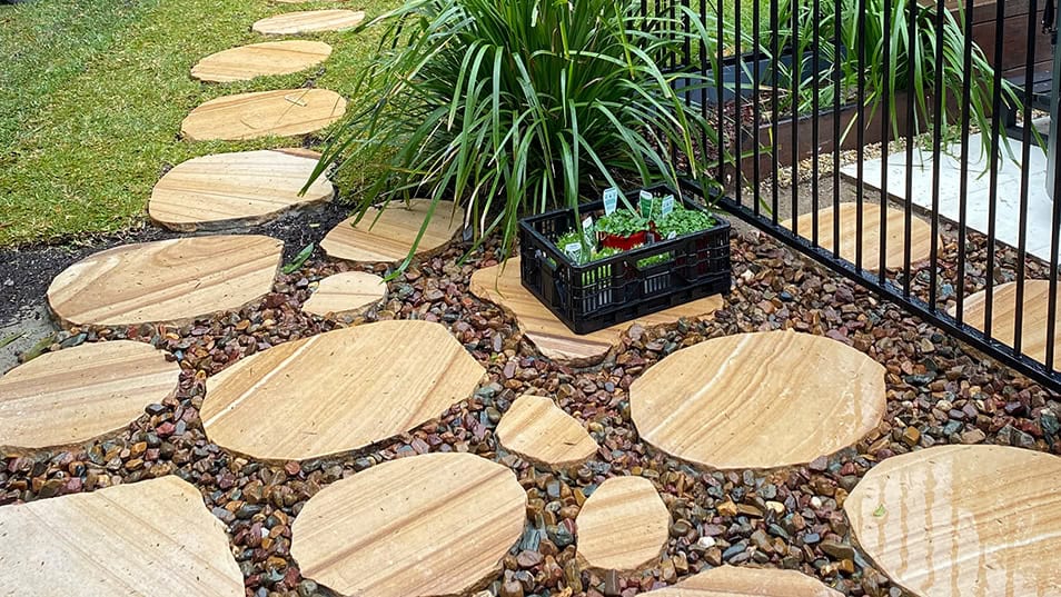 Sandstone Stepping Stones Sandstone stepping stone pathway through green garden.
